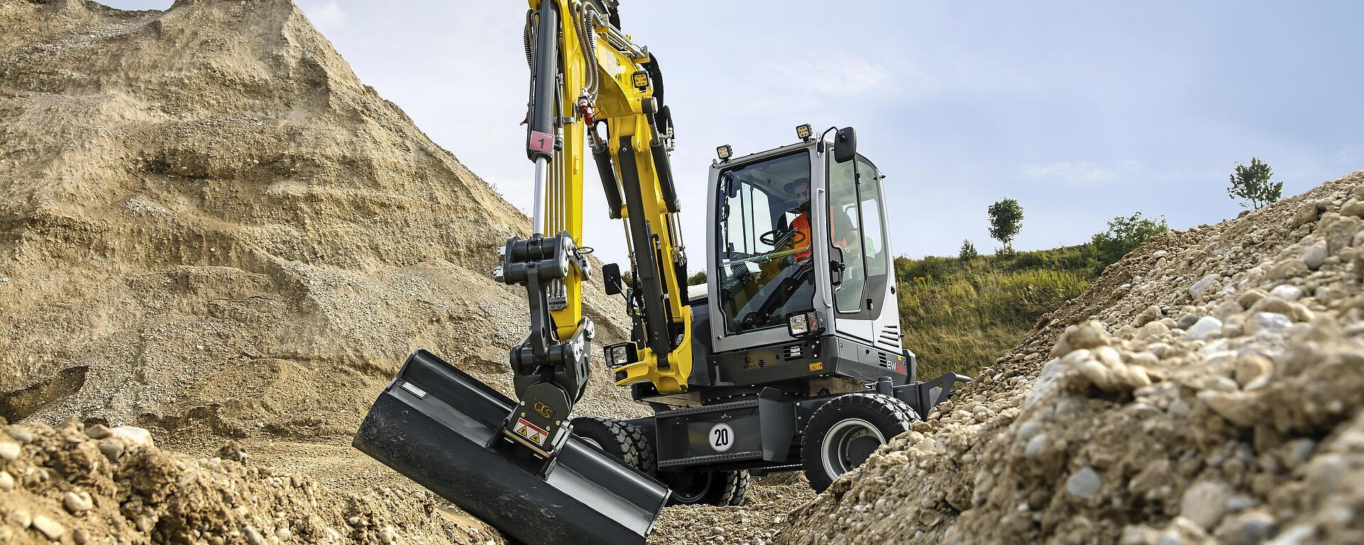 EW65 mobile excavator excavating a pipe trench in the filed